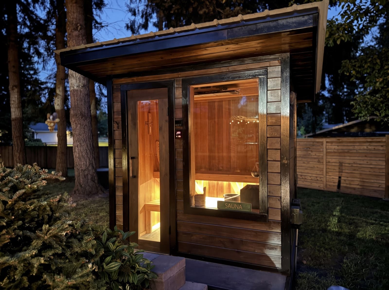 Clear Western Red Cedar sauna exterior detail with glazing and standing-seam roof