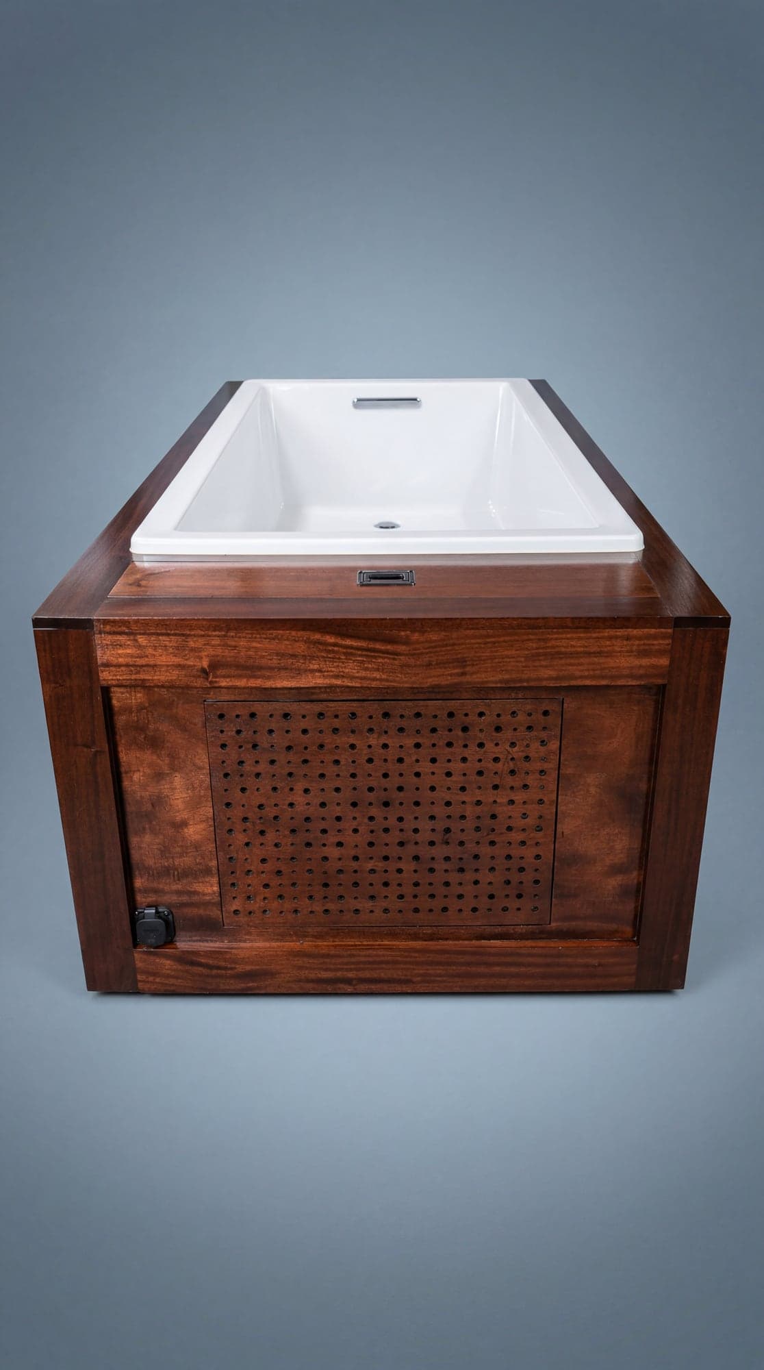 Bathing basin above the mahogany cold plunge enclosure and perforated ventilation panel