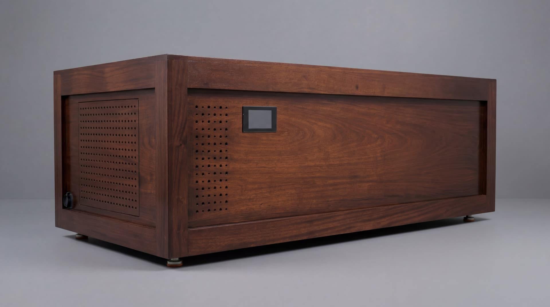 Mortise-joined mahogany cold plunge, studio three-quarter view — perforated chiller-vent panel, integrated control display, leveling feet, on a seamless gray backdrop